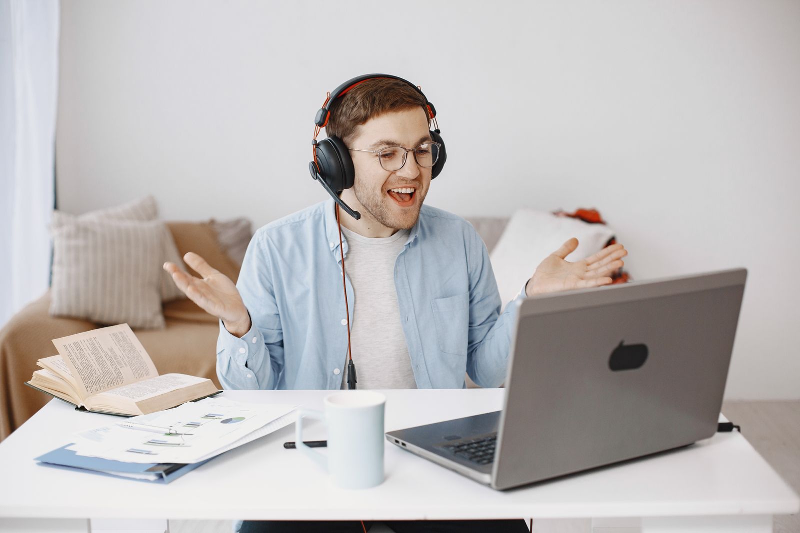 Man wearing a headset during an online laptop meeting